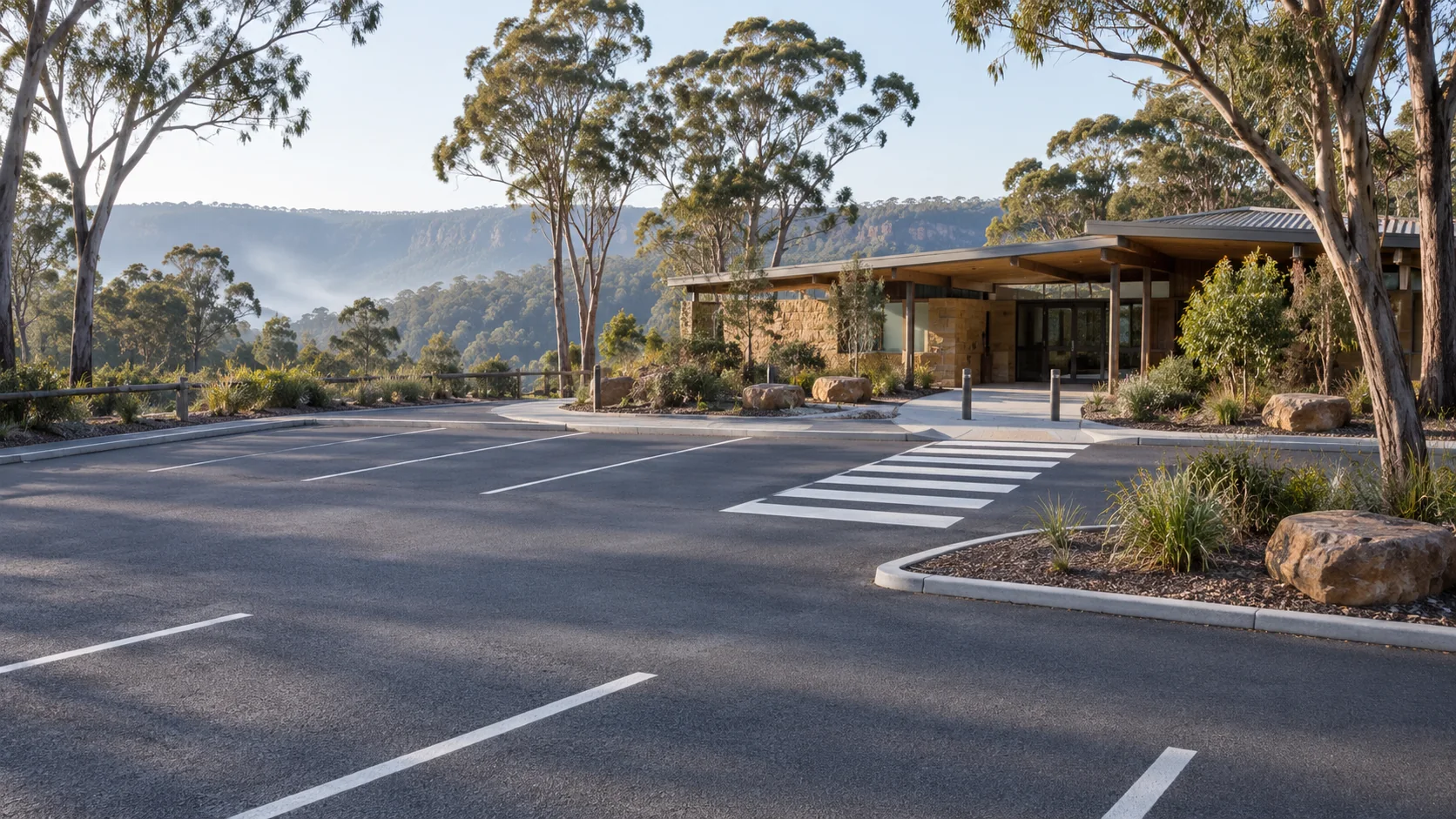 Illustrative visitor facility with parking bay markings and a pedestrian crossing among eucalyptus trees
