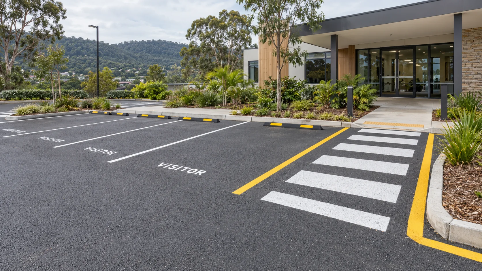 Illustrative visitor car park with marked bays and a crossing leading to a commercial entrance